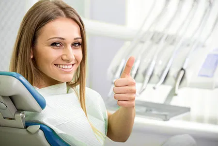 smiling woman giving a thumbs up